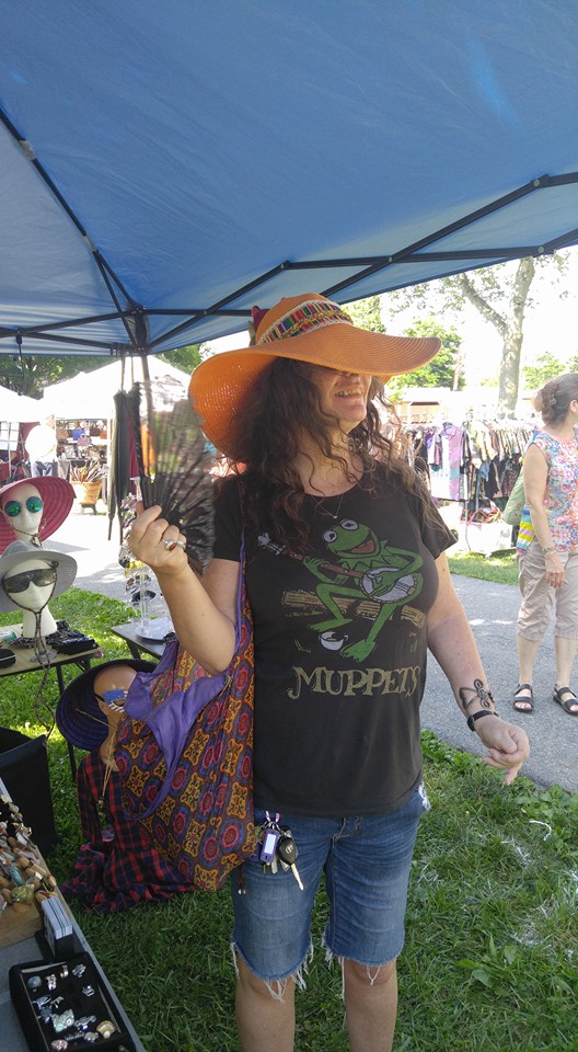 Customer donning her new hat at the Common Ground Festival in July
