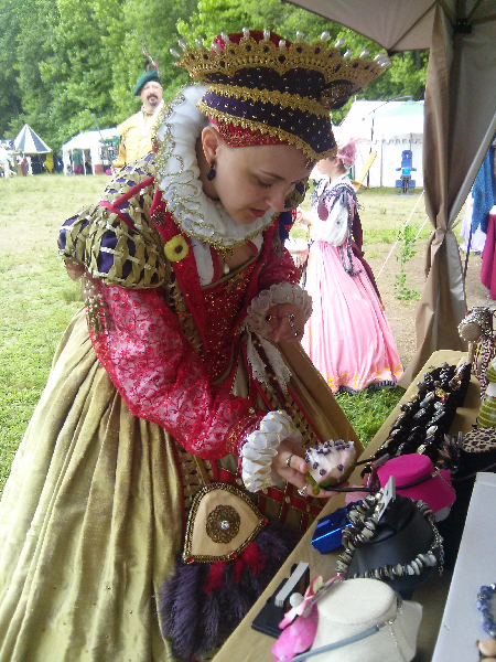 Her Majesty Queen Elizabeth admires necklace